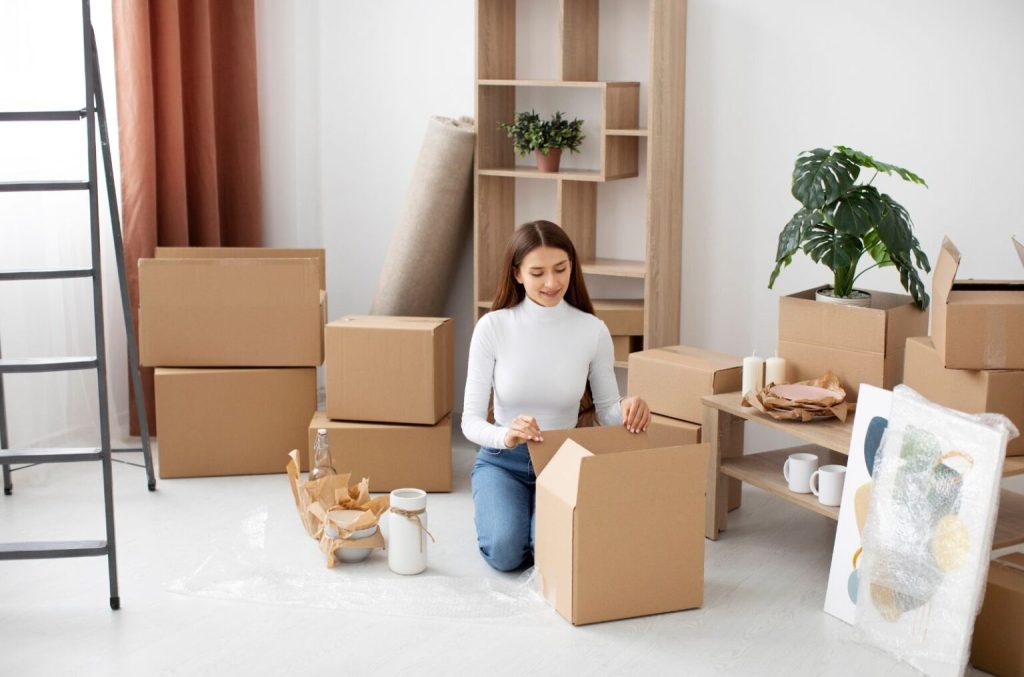 Girl wrapping and protecting furniture and fragile items for transport