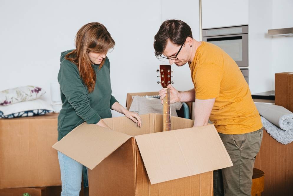 Packed moving boxes with fragile and restricted items set aside for safe transport.